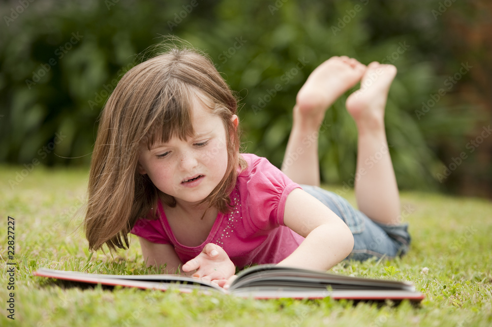 little girl laying in grass reading little girl laying in grass reading
