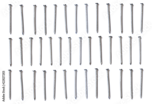 Three rows of steel nails isolated on white