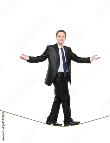 A businessman walking on a high tightrope photo