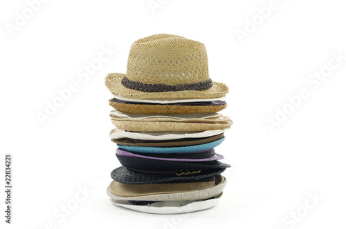 Stacks of straw hats on white