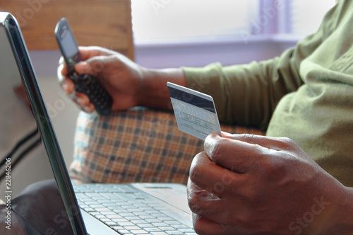 Canvas-taulu Man With Laptop Using Credit Card and Cellphone