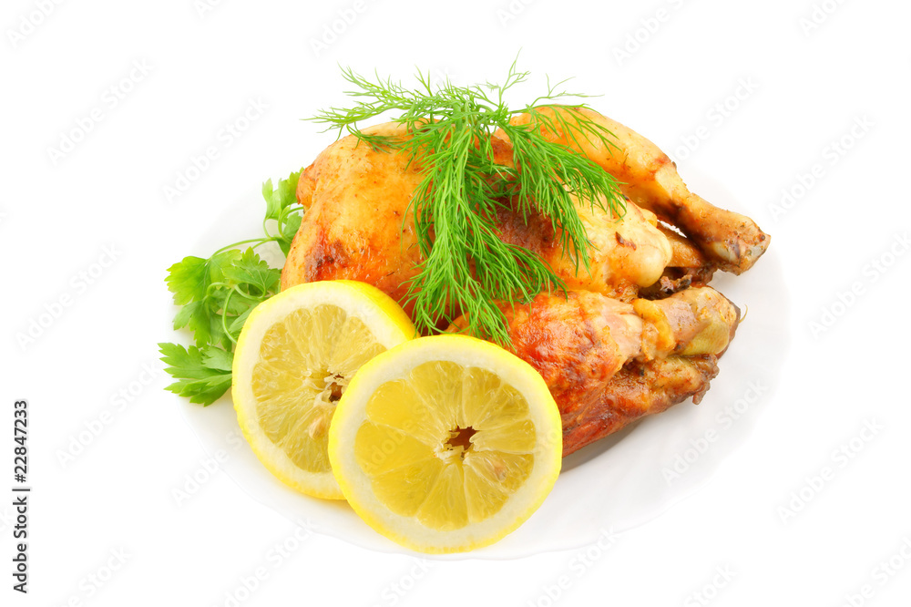 Grilled chicken with lemon and greens on plate isolated Grilled chicken with lemon and greens on plate isolated