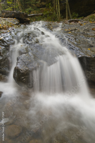 Fototapeta Naklejka Na Ścianę i Meble -  Beautiful flowing waterfall in the forest