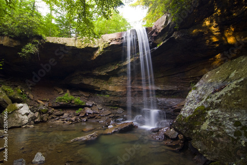 Secluded waterfall in a forest photo