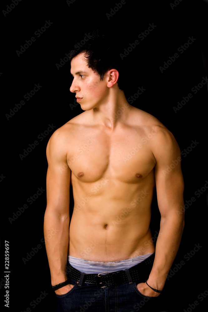 Young man with atletic body on black background Young man with atletic body on black background