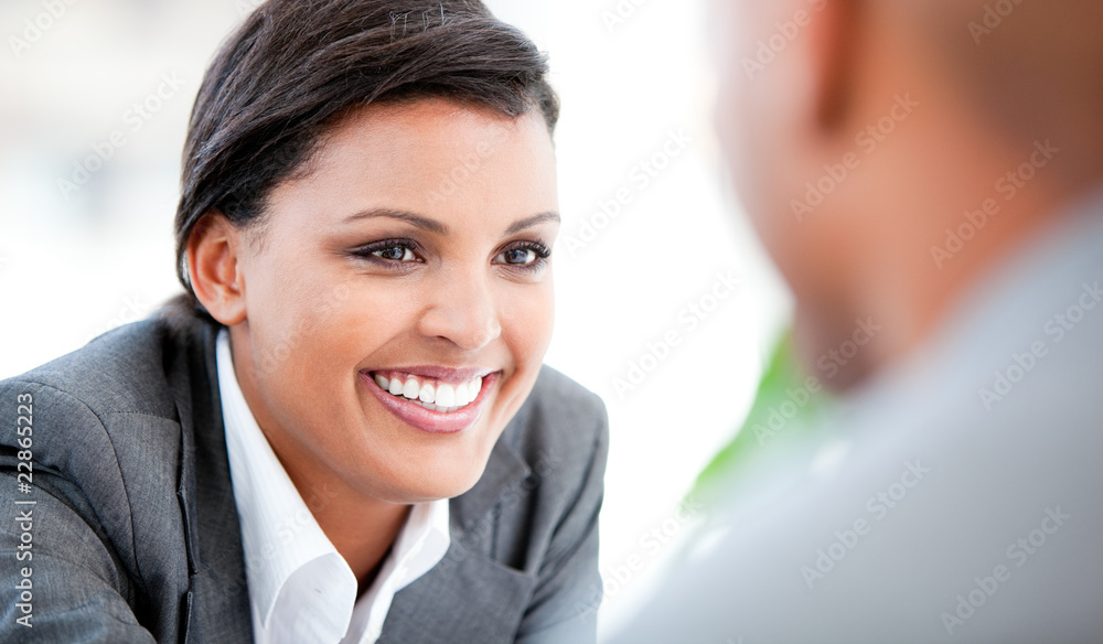 Portrait of a smiling businesswoman talking with her colleague Portrait of a smiling businesswoman talking with her colleague
