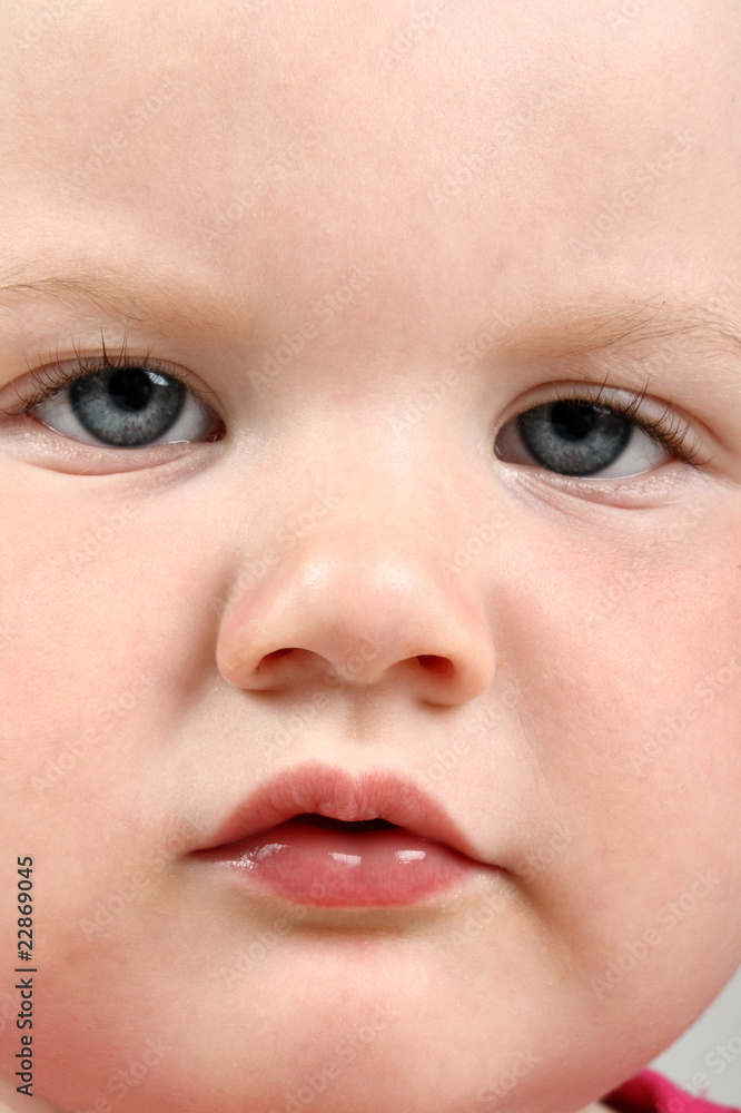 Detailed portrait of frowned baby looking at camera Detailed portrait of frowned baby looking at camera