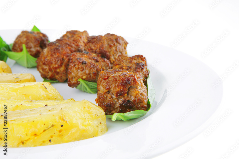 served meatballs on basil leaf