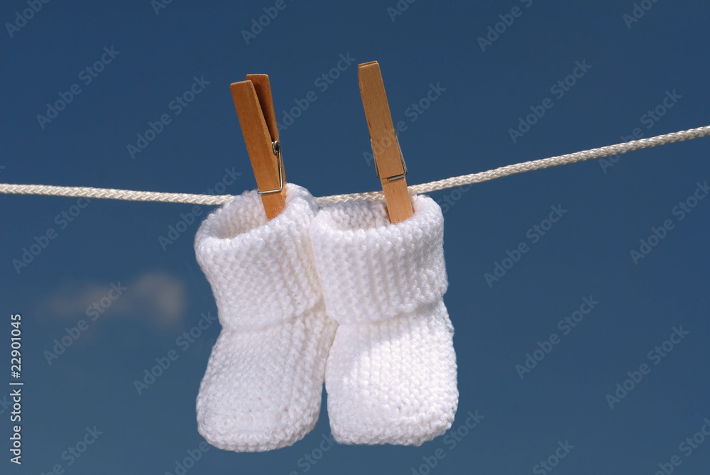 concept bébé: chaussons sur fil à linge Stock Photo | Adobe Stock