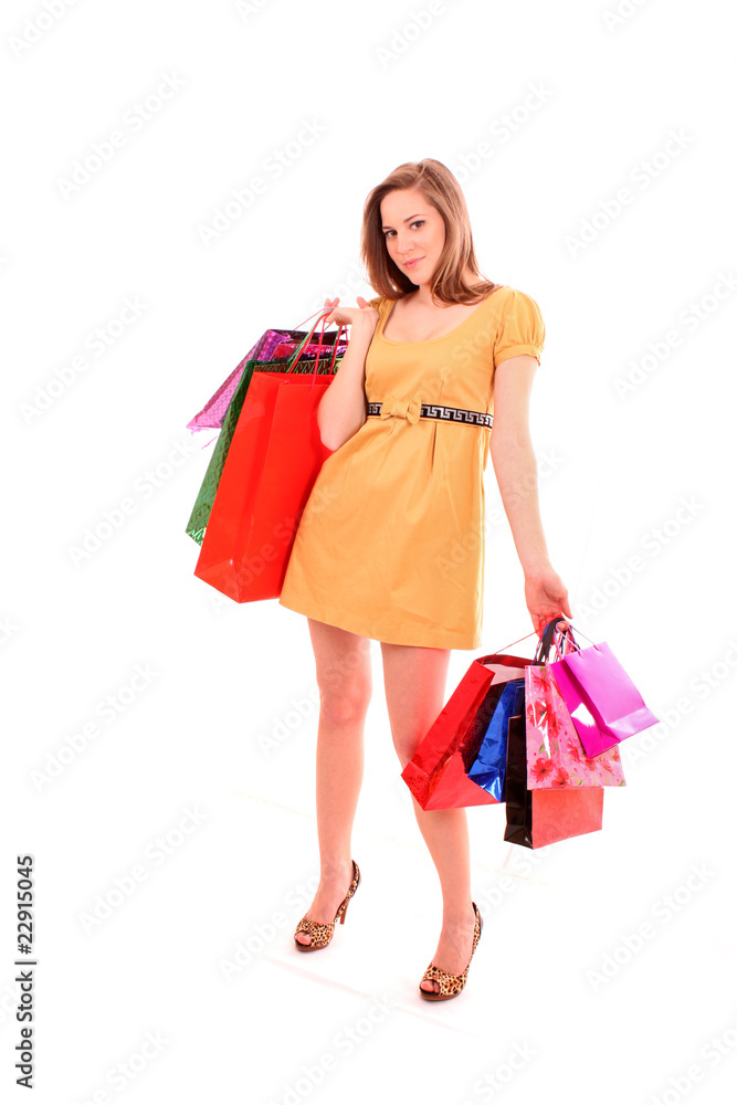 Beautiful young woman with color shopping bags in her hand. Isol