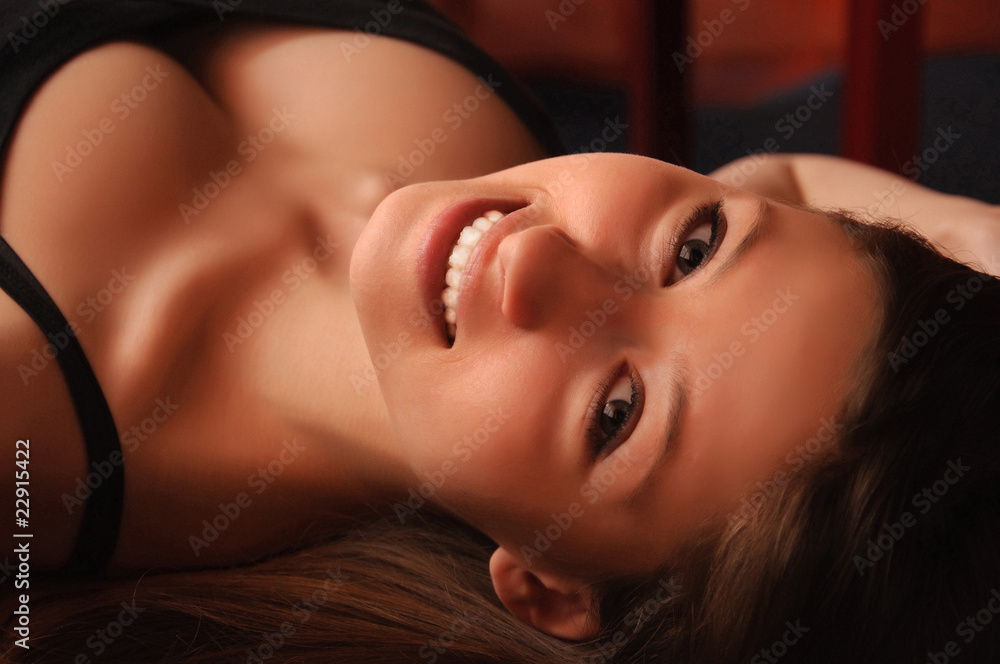 A portrait of young beautiful pretty girl lying on the sofa. A portrait of young beautiful pretty girl lying on the sofa.