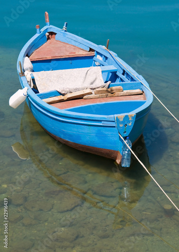 Coloured rowboat in clear sea.