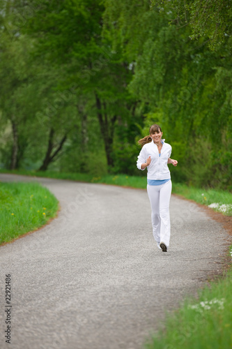 Jogging - sportive woman running on road in nature © CandyBox Images