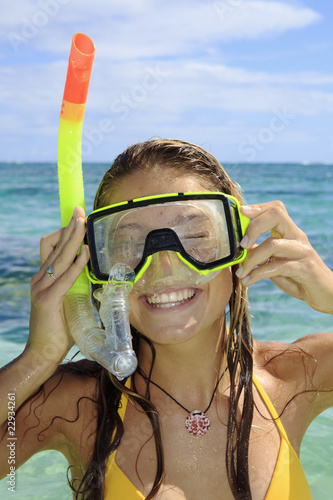 teenage girl in the ocean with mask and snorkel.