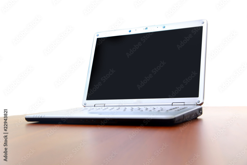 Modern laptop isolated on white with reflections on glass table. Modern laptop isolated on white with reflections on glass table.