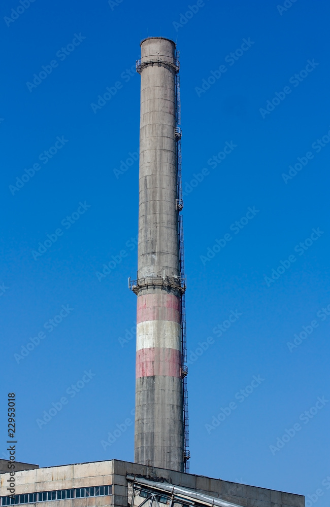 Chimney pipe against the blue sky