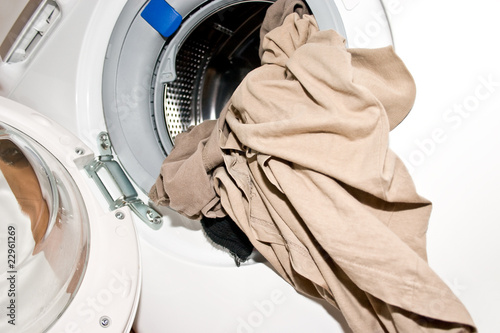 open washing machine with laundry