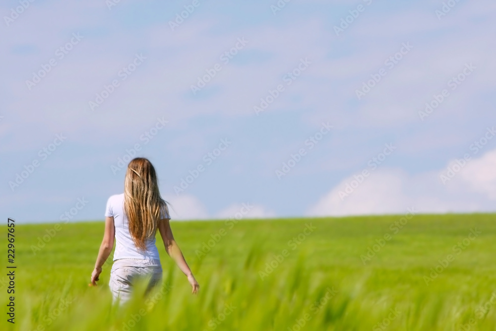 young girl going away in green field young girl going away in green field