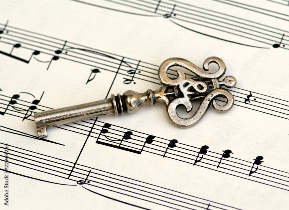 Skeleton key with treble clef & lire on classic sheet music Skeleton key with treble clef & lire on classic sheet music