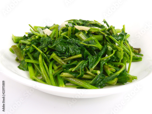 Fried spinach cabbage. Close up on white background