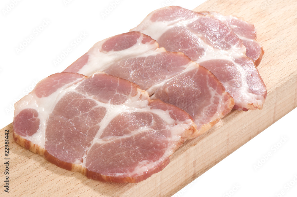 Sliced cooked pork neck on a cutting board isolated