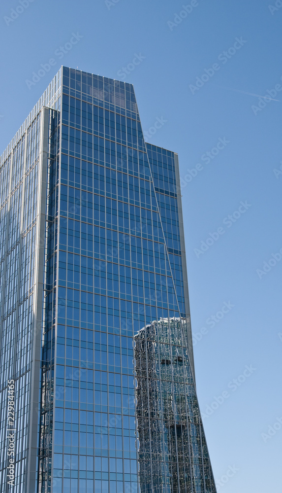 Blue Office Tower with Round Building Reflection