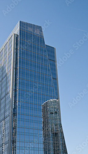 Blue Office Tower with Round Building Reflection