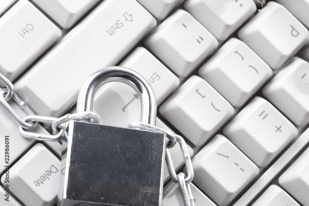 Computer keyboard secured with chain and padlock.. Computer keyboard secured with chain and padlock..