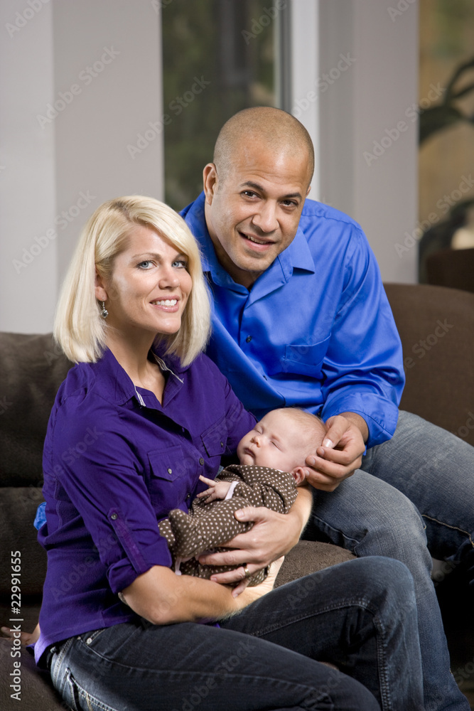 Happy parents cradling sleeping baby at home Happy parents cradling sleeping baby at home