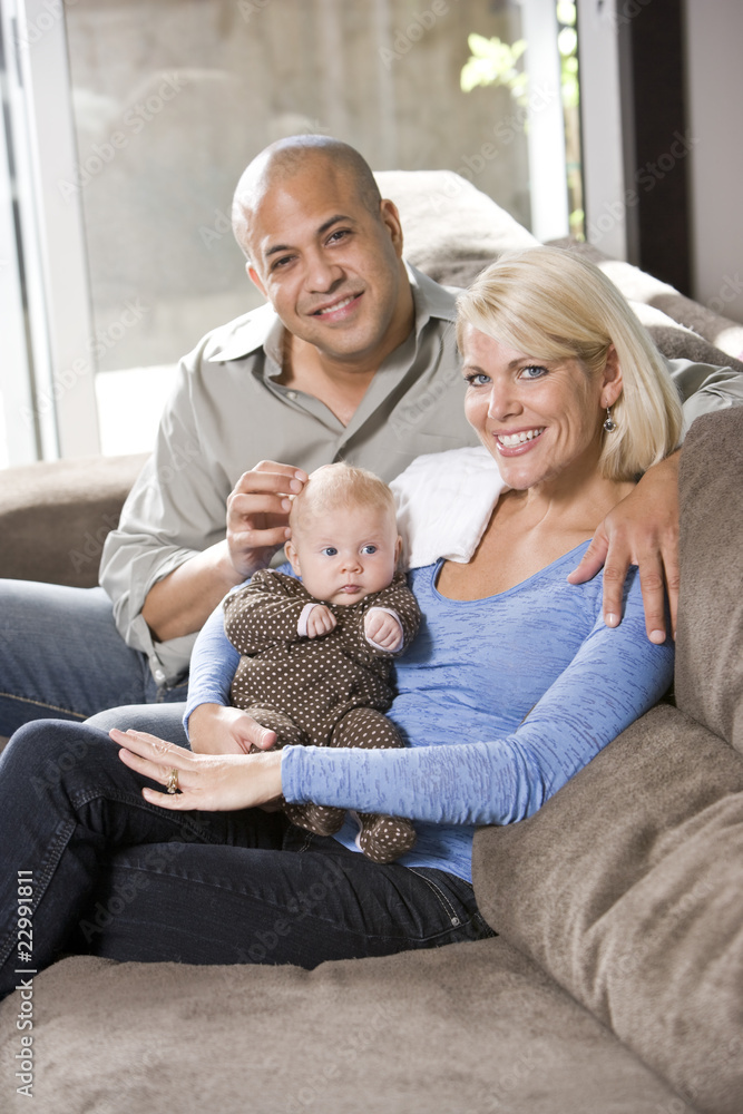 Loving parents with baby sitting on lap at home Loving parents with baby sitting on lap at home