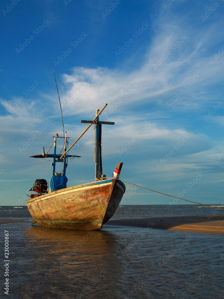 fishing boat in blue sky