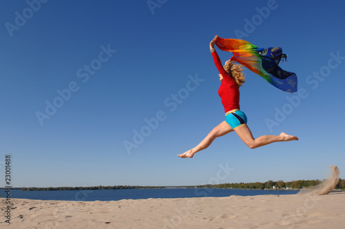 WOMAN JUMPING ON THE BEACH