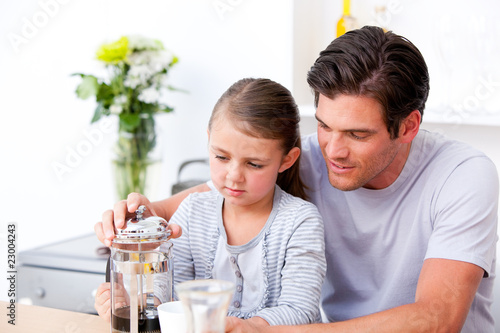 Attentive father and his daughter having breakfast together