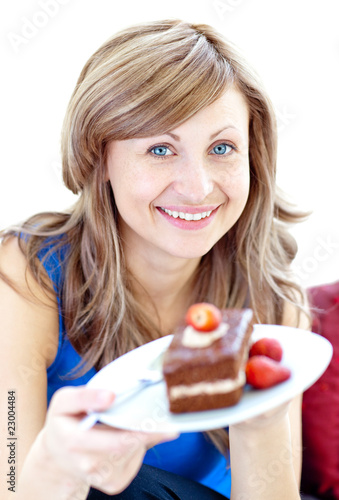 Smiling woman holding a piece of chocolate cake