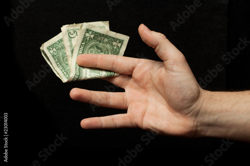 A male hand holding dollars