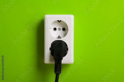 White electric socket on the wall.