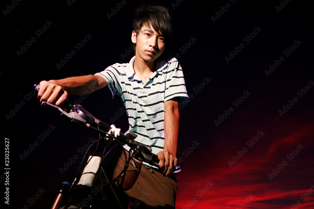 Obraz premium young asian man with bike
