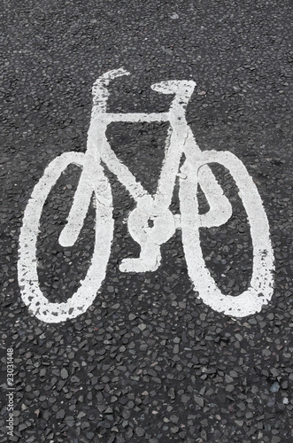 White cycle lane sign on asphalt.