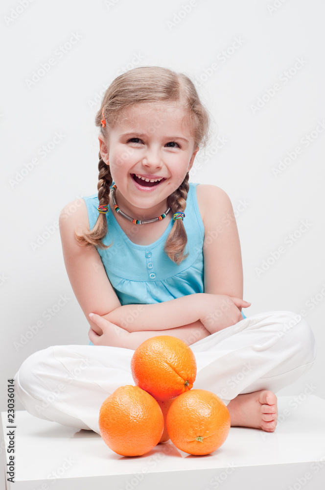 Happy little girl and orange fruits Happy little girl and orange fruits