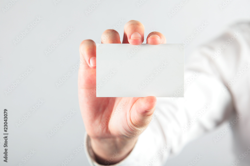 Business card blank in a hand on the white Business card blank in a hand on the white