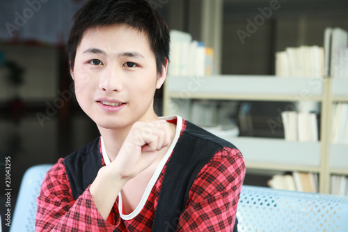 asian yong boy sit in the room