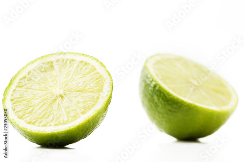 zwei halbe limonen auf weißem hintergrund