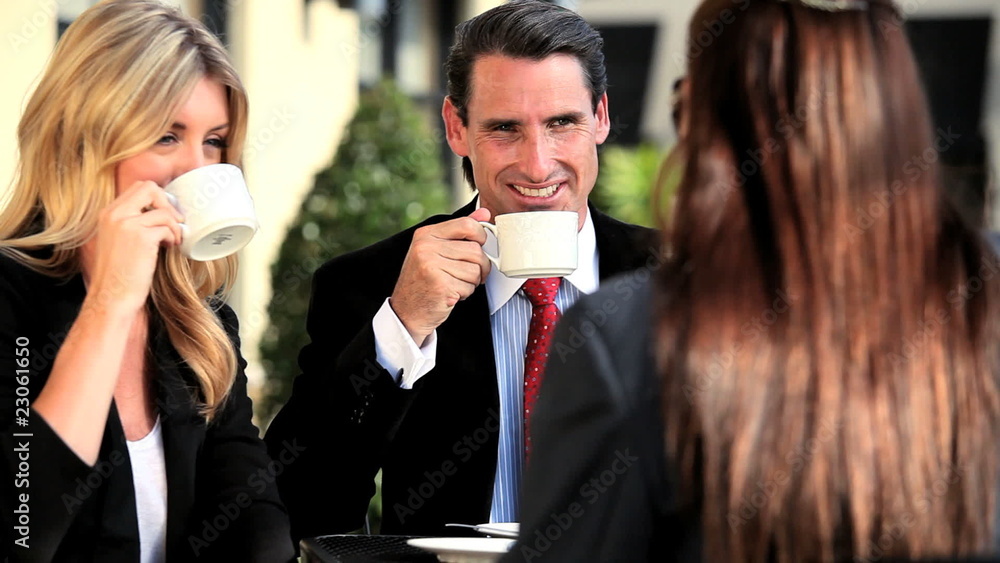 Three young business executives celebrating at outdoor café Three young business executives celebrating at outdoor café