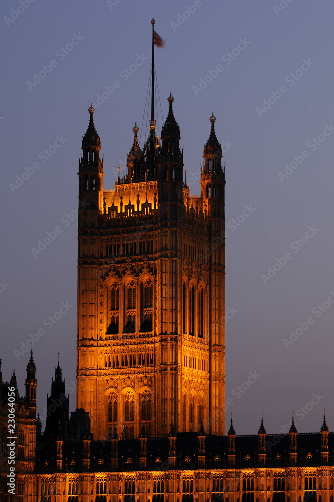 illuminated tower with flag of Houses of Parliament