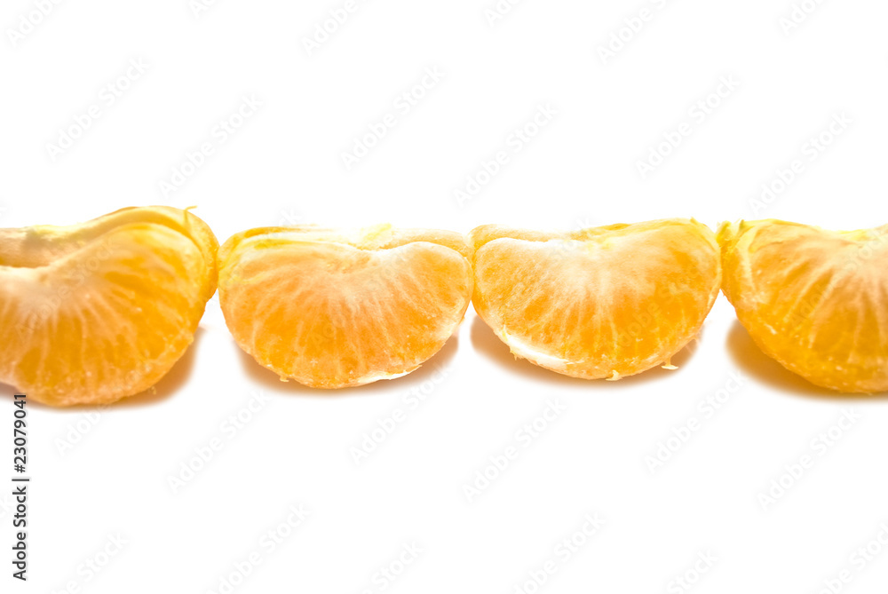 Row of mandarin segments. Focus in the center. Isolated over whi Row of mandarin segments. Focus in the center. Isolated over whi