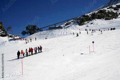 Skiers on alpine ski slope