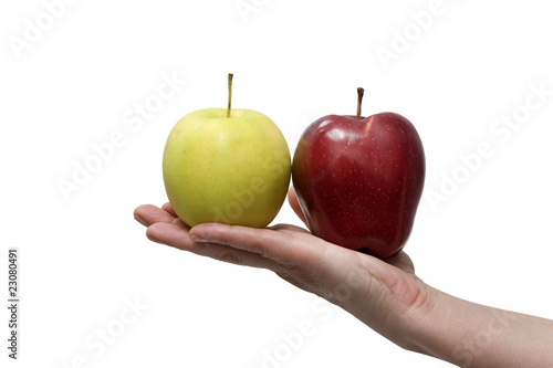 a yellow and a red apple in the hand