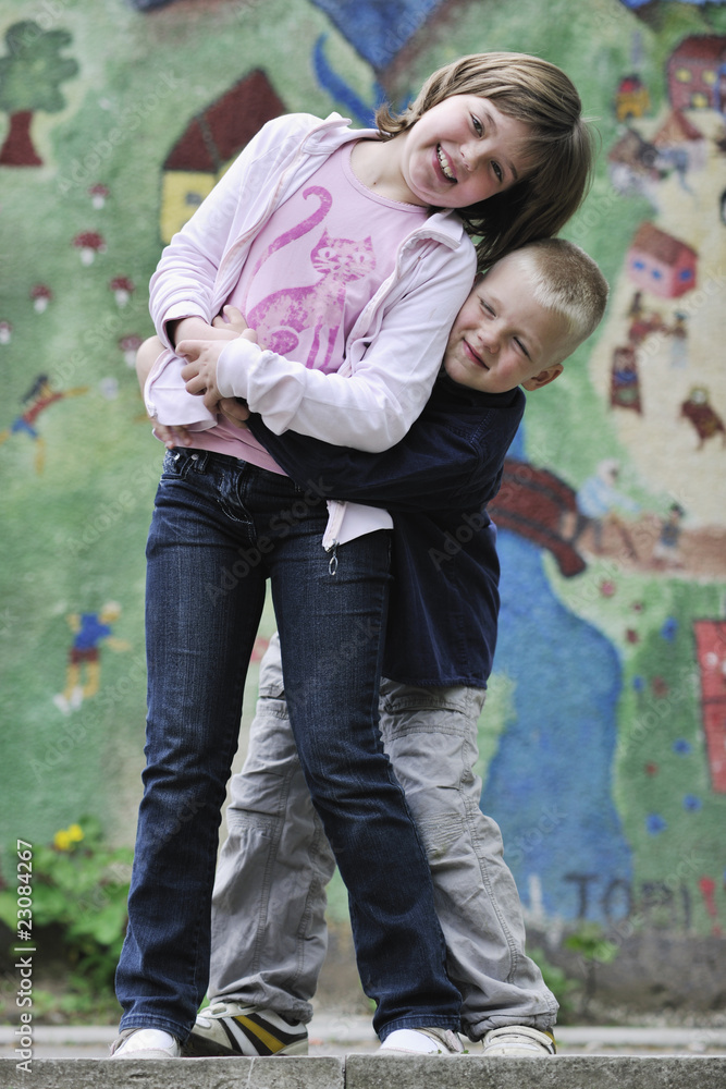 happy brother and sister outdoor in park happy brother and sister outdoor in park