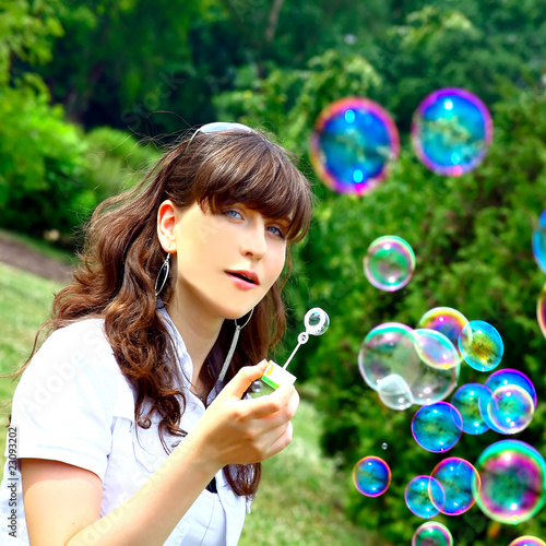 girl blowing bubbles in spring time