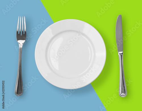 Knife, plate and fork on colorful background